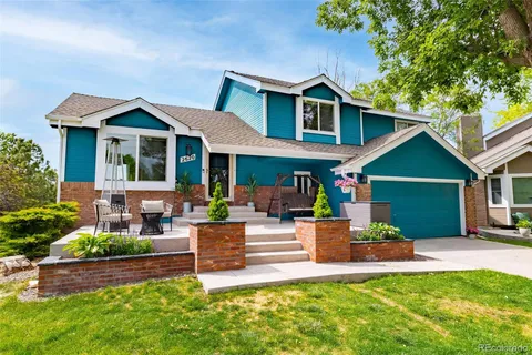 a view of a house with a yard and sitting area
