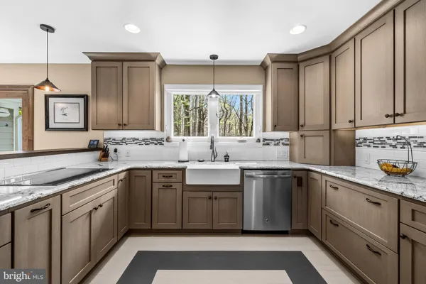a kitchen with a sink stove and cabinets
