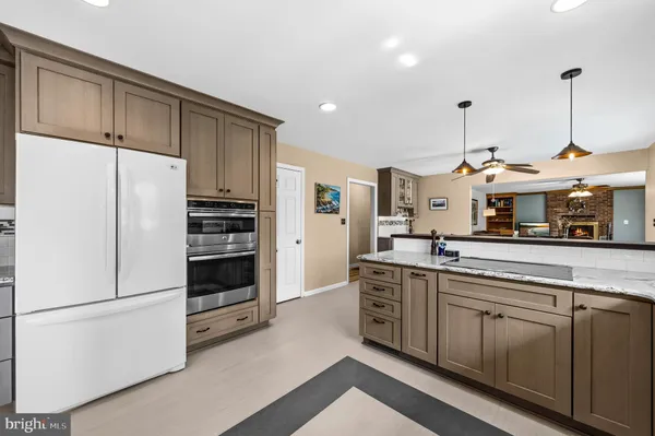 a kitchen with stainless steel appliances a refrigerator sink and cabinets