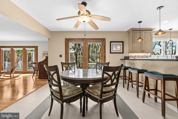 a dining room with furniture a chandelier and wooden floor