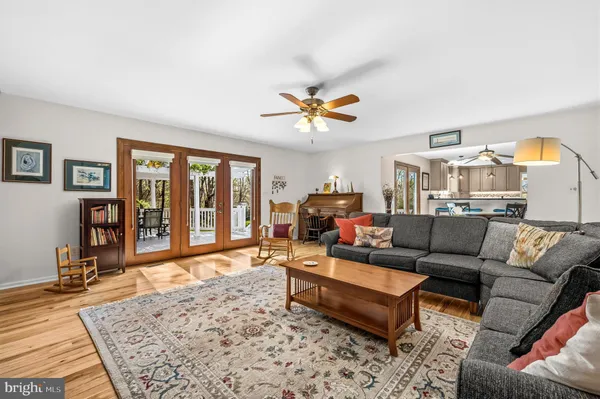 a living room with furniture ceiling fan and a rug