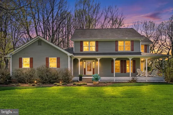 a front view of house with yard and outdoor seating