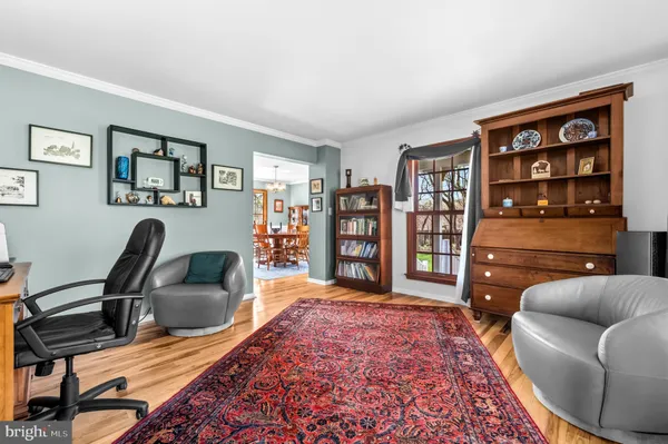 a living room with furniture and a book shelf
