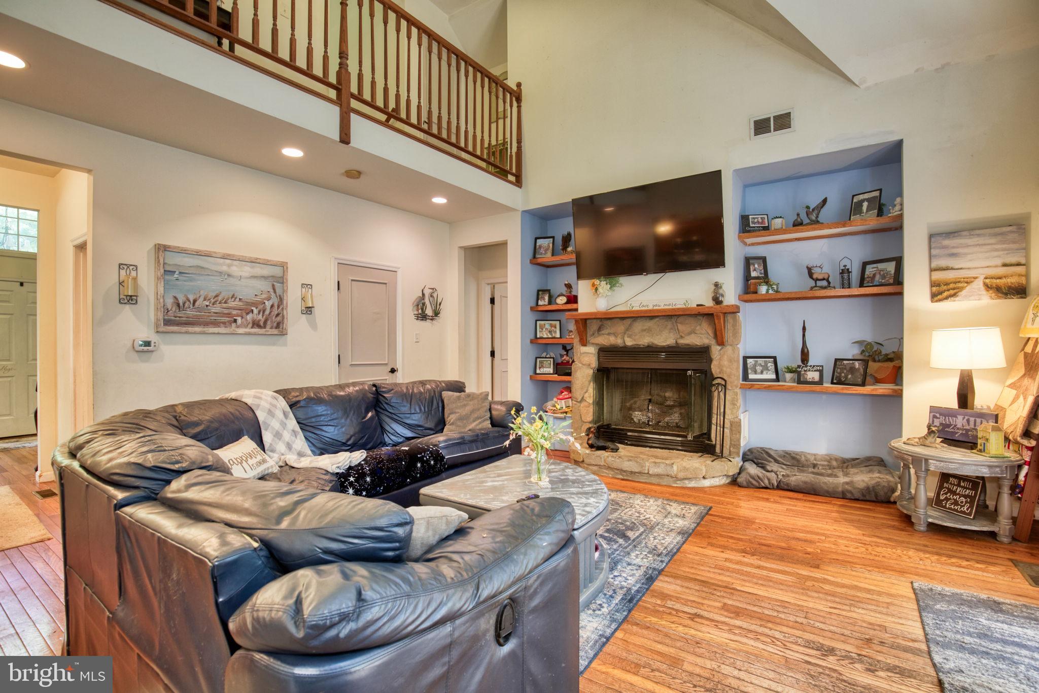 120 Twin Harbor Road Reedville, VA 22539 - Photo 12 of 45 FAMILY ROOM,FIREPLACE AND UPSTAIRS VIEW