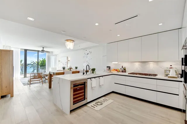 a kitchen with stove a sink and cabinets