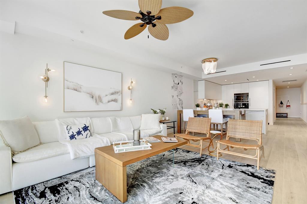 1116 North Ocean Boulevard, Unit 303 Pompano Beach, FL 33062 - Photo 12 of 52 a living room with furniture and a rug