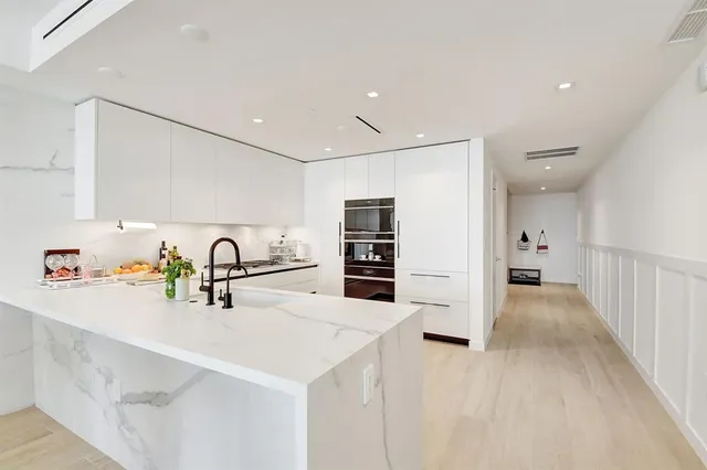 a view of a kitchen with a sink and refrigerator