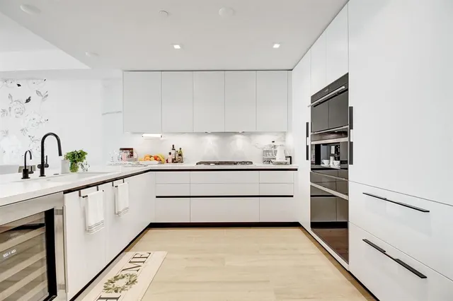 a kitchen with granite countertop white cabinets and white appliances