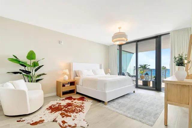 a bedroom with a bed and a potted plant