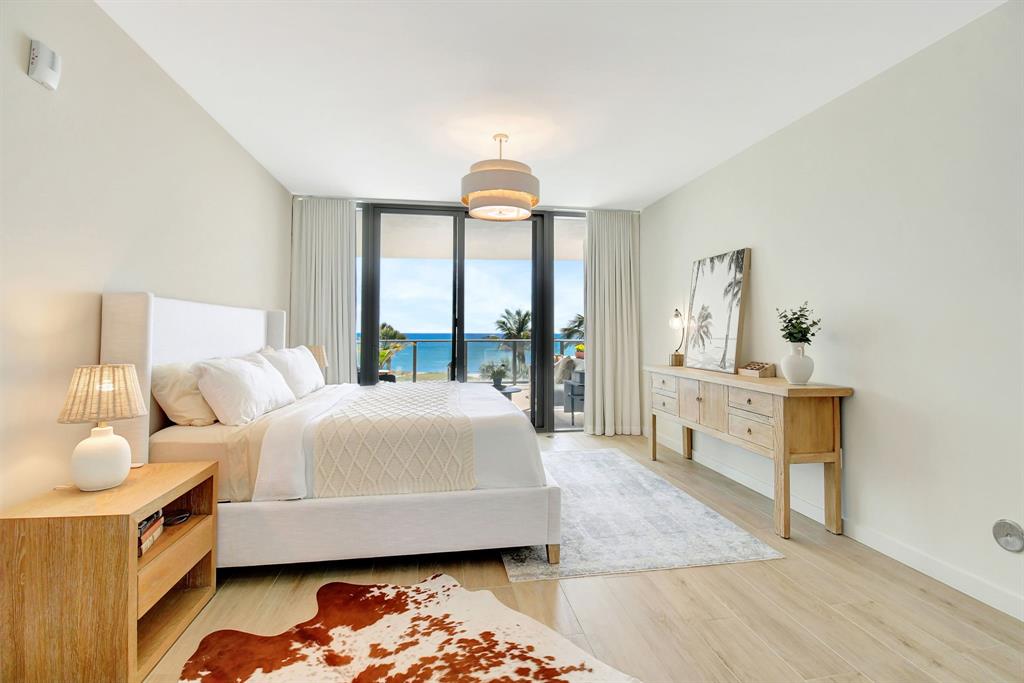 1116 North Ocean Boulevard, Unit 303 Pompano Beach, FL 33062 - Photo 18 of 52 a bedroom with a bed and wooden floor