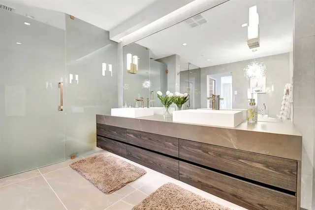 a large bathroom with a double vanity sink and a mirror