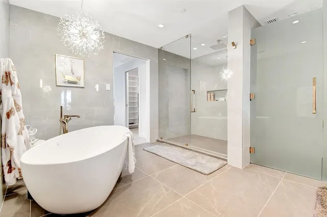 a bathroom with a bathtub and shower