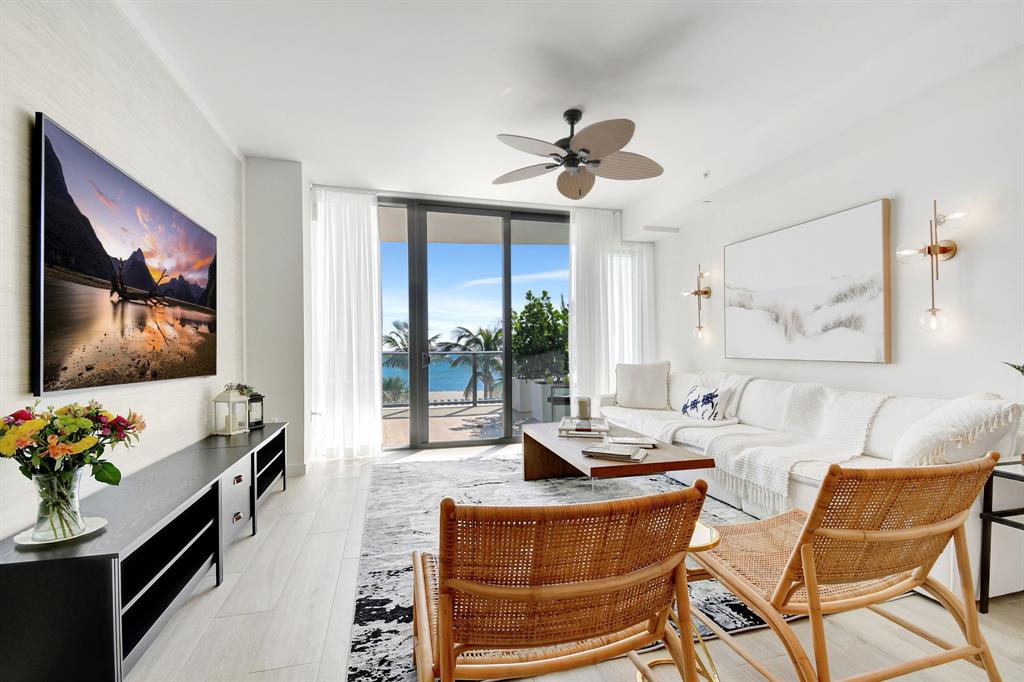 1116 North Ocean Boulevard, Unit 303 Pompano Beach, FL 33062 - Photo 3 of 52 a living room with fireplace furniture and a flat screen tv