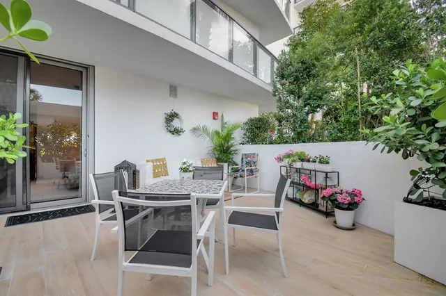 a view of a dining room with furniture and a potted plant