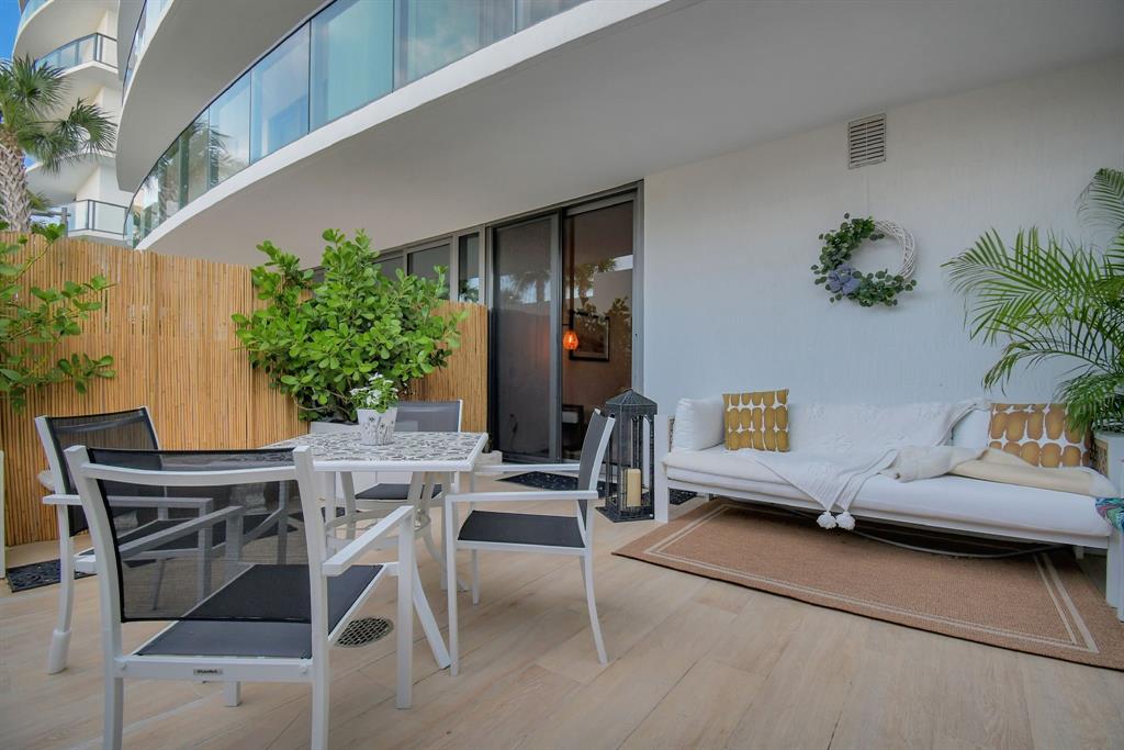 1116 North Ocean Boulevard, Unit 303 Pompano Beach, FL 33062 - Photo 35 of 52 a view of a dining room with furniture and a potted plant