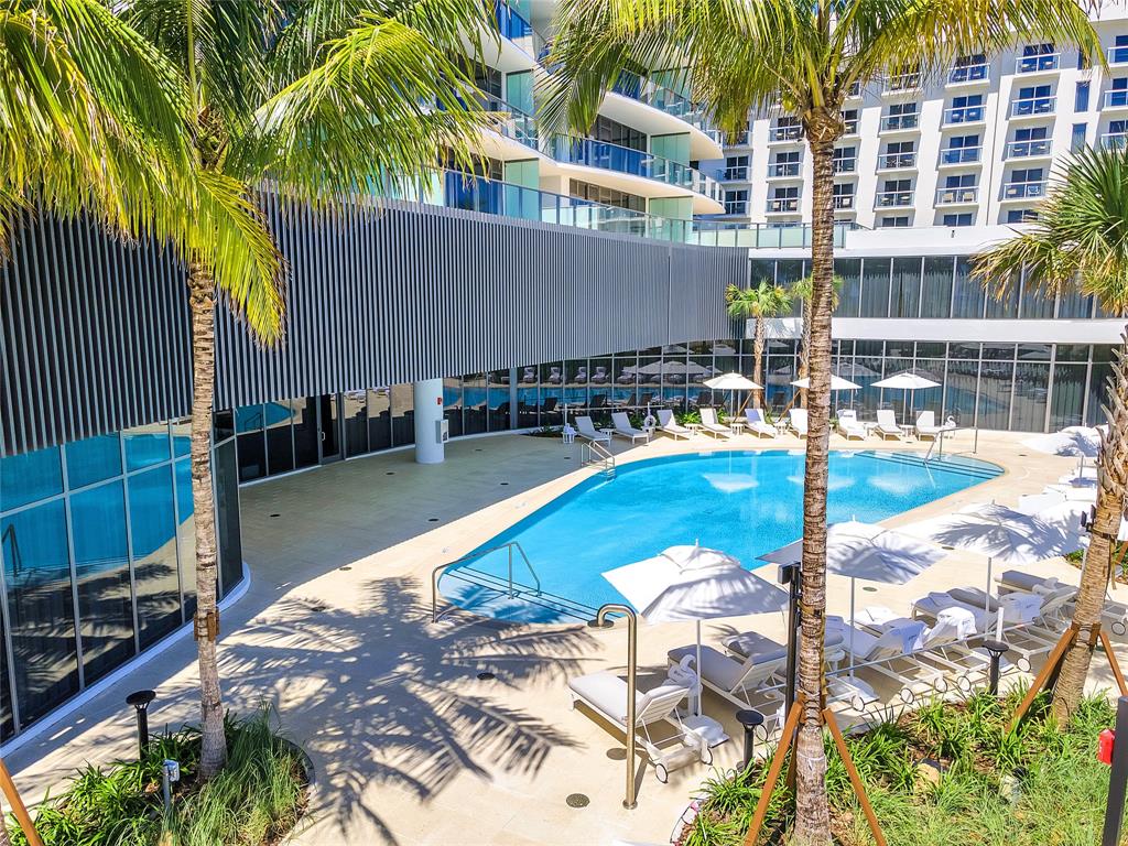 1116 North Ocean Boulevard, Unit 303 Pompano Beach, FL 33062 - Photo 39 of 52 a view of a swimming pool with a patio