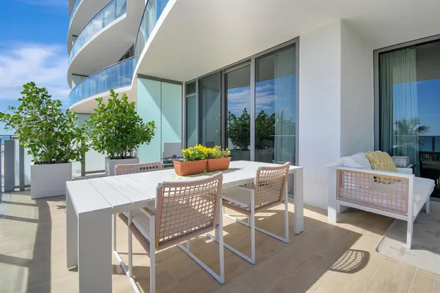 a outdoor space with patio the couches and a potted plant on a table