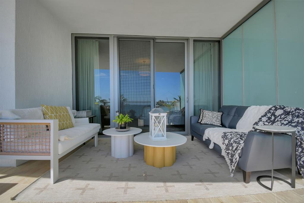 1116 North Ocean Boulevard, Unit 303 Pompano Beach, FL 33062 - Photo 8 of 52 a living room with furniture and a potted plant