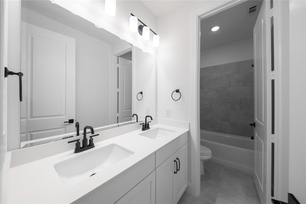 2715 Triumph Court Heath, TX 75126 - Photo 15 of 30 a bathroom with a sink double vanity and a mirror