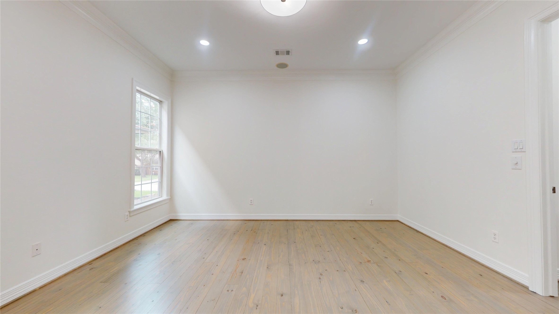 4050 Dumbarton Street Houston, TX 77025 - Photo 26 of 48 View of First Floor Primary Bedroom with updated lighting, and refinished Pinewood Flooring.