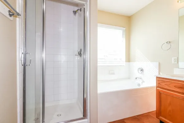 a bathroom with a bathtub and a shower