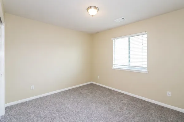 an empty room with a empty space and a window