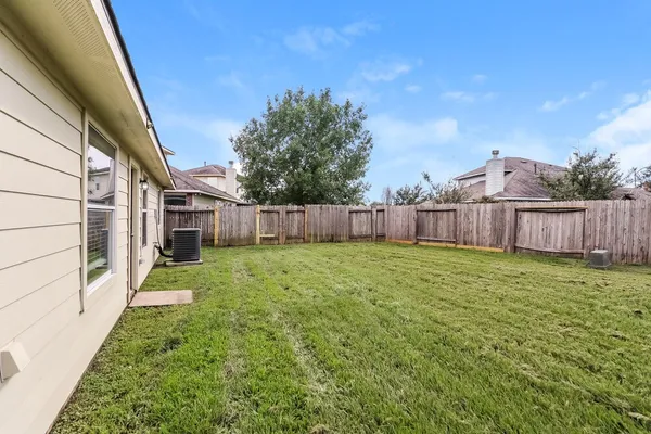 a view of a backyard with large trees