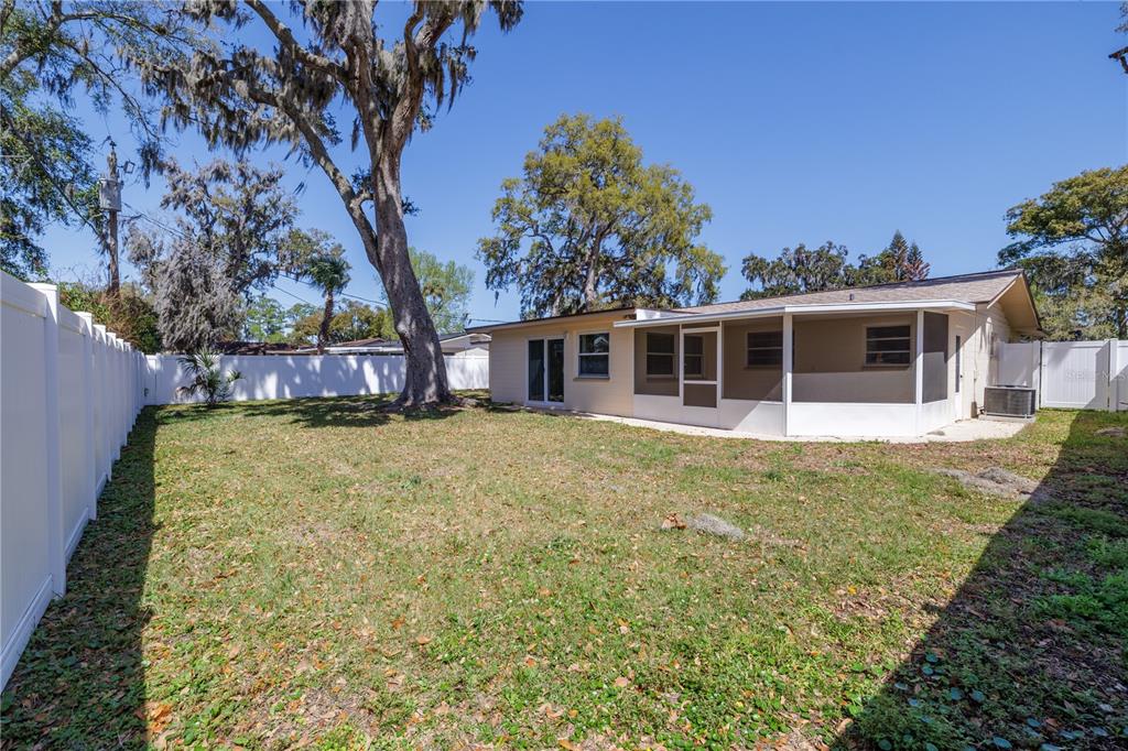 1016 Cherokee Ranch Road Holly Hill, FL 32117 - Photo 23 of 23 a view of a house with a large tree and a yard