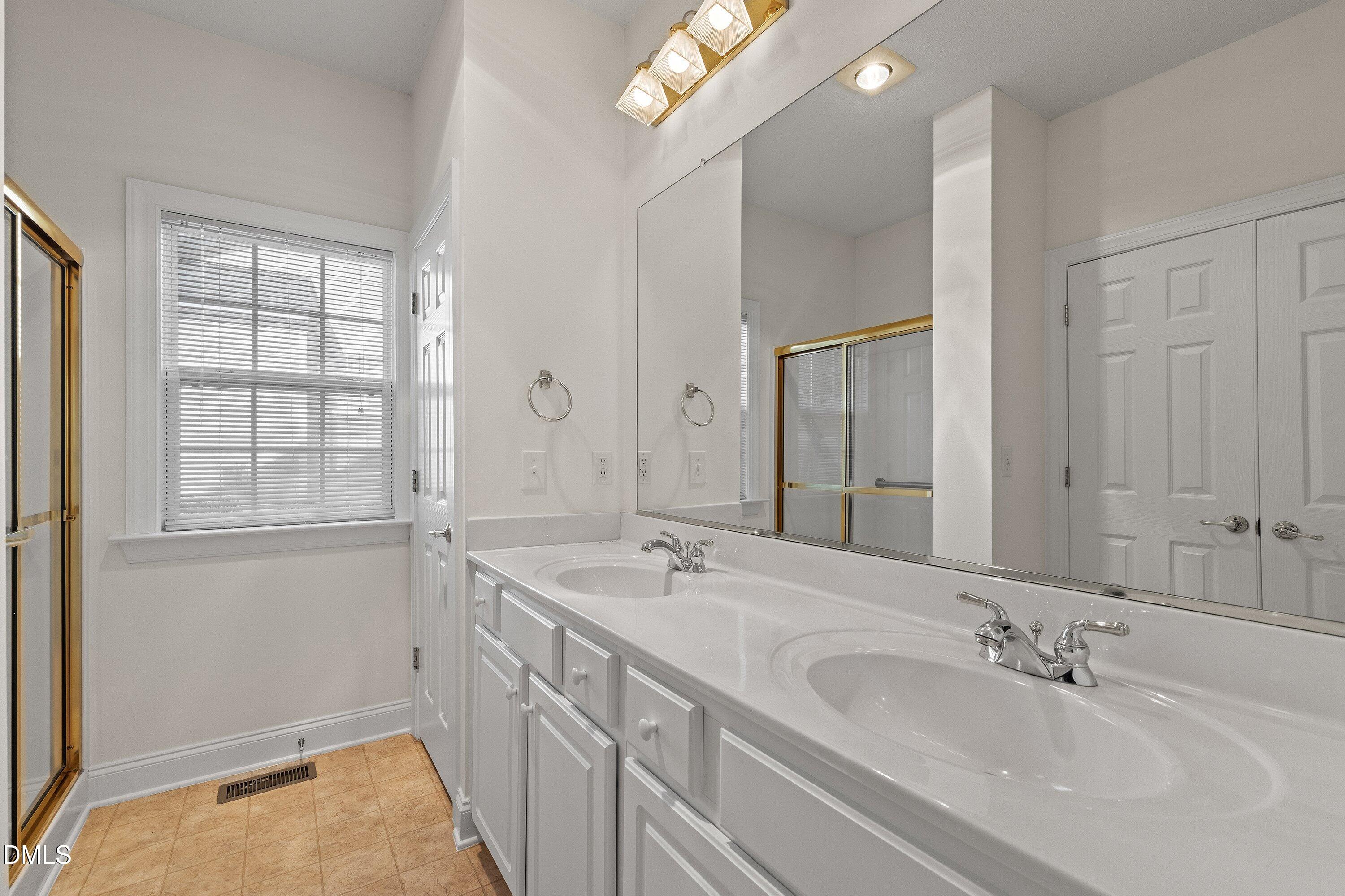 105 Rockport Ridge Way Cary, NC 27519 - Photo 34 of 43 a bathroom with a sink and a mirror