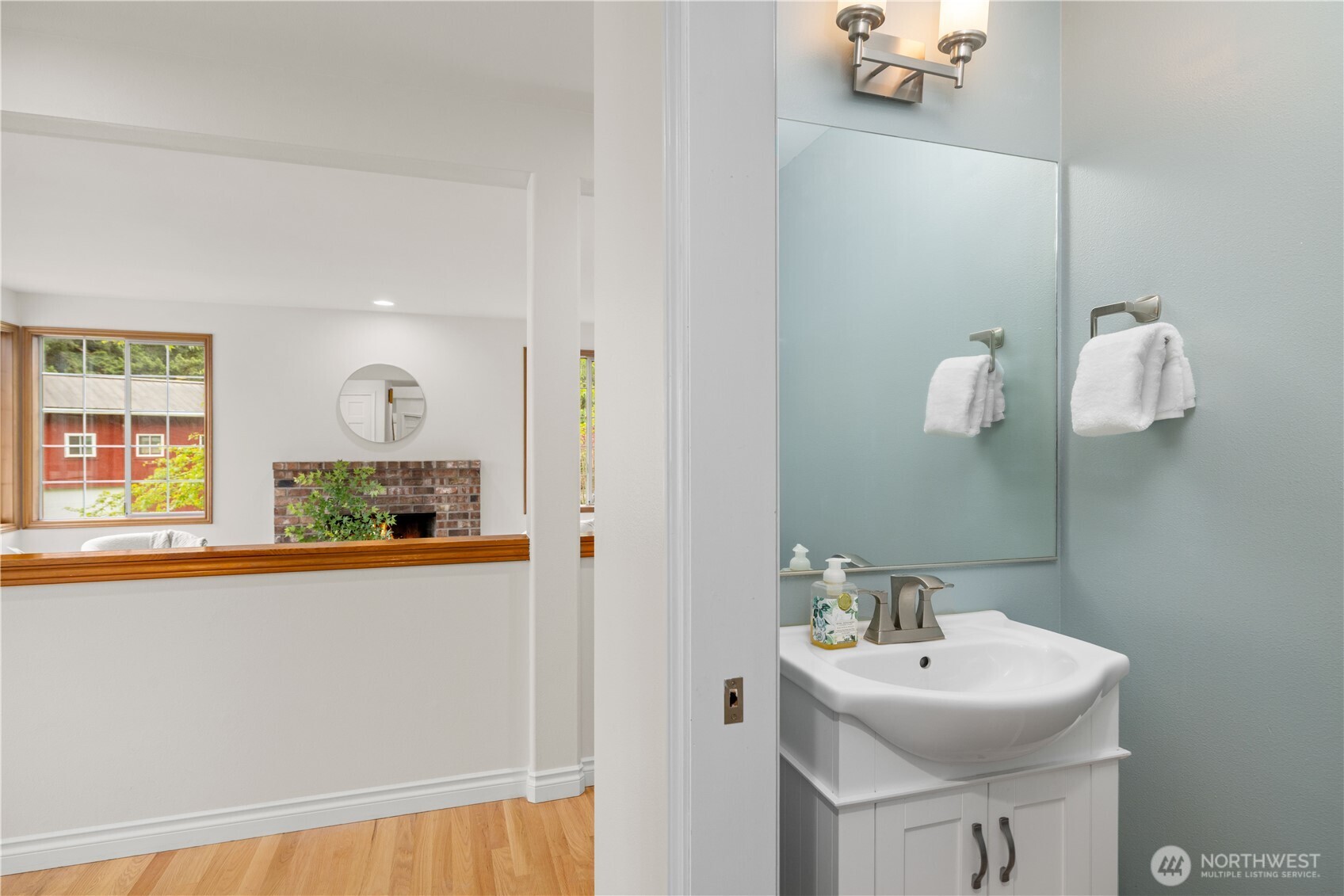 8484 Northeast County Park Road Bainbridge Island, WA 98110 - Photo 12 of 35 a bathroom with a sink and a mirror