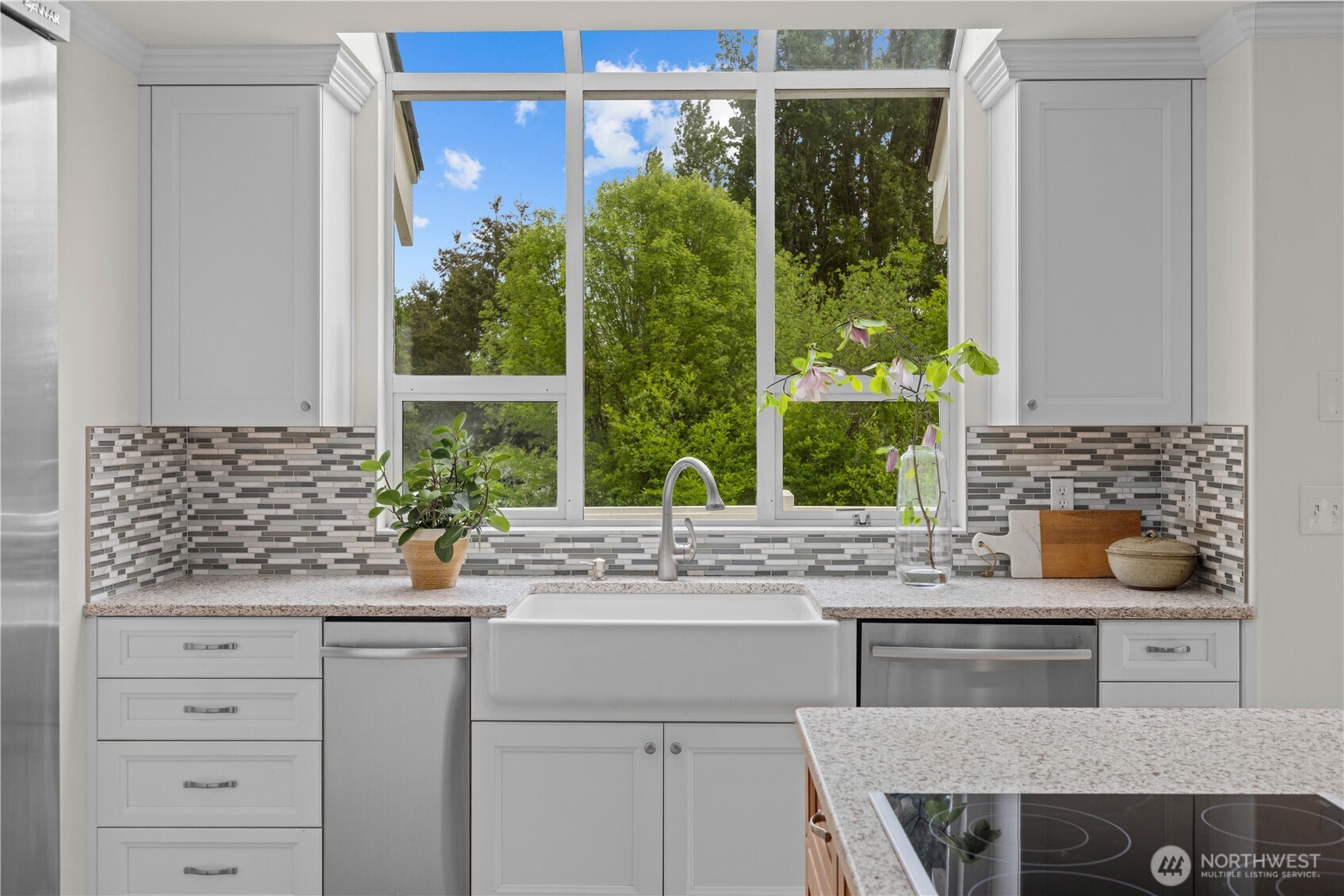8484 Northeast County Park Road Bainbridge Island, WA 98110 - Photo 19 of 35 a kitchen with a granite countertop sink window and white cabinets