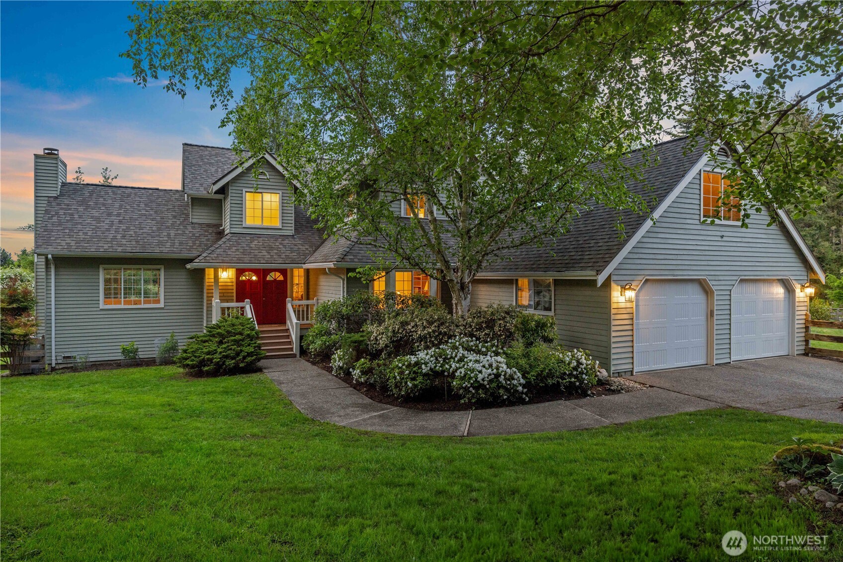 8484 Northeast County Park Road Bainbridge Island, WA 98110 - Photo 2 of 35 a front view of a house with a yard and garage