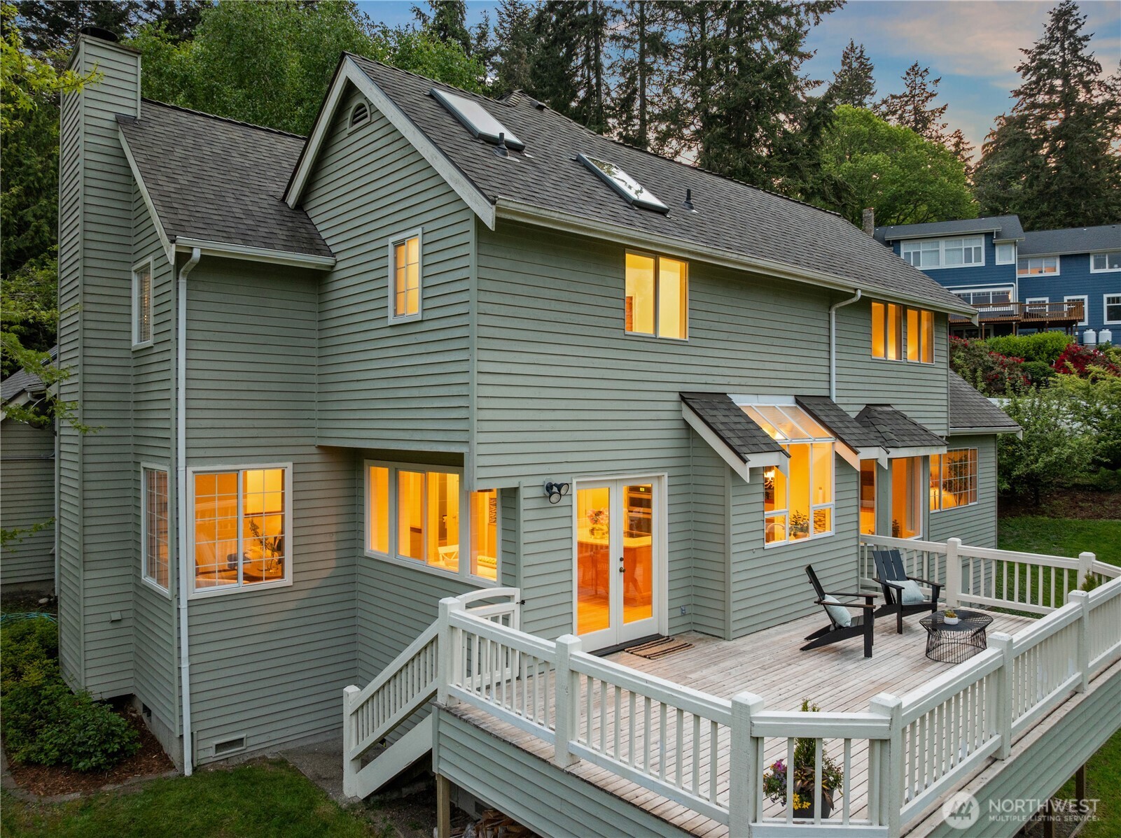 8484 Northeast County Park Road Bainbridge Island, WA 98110 - Photo 32 of 35 a view of a house with wooden deck and furniture