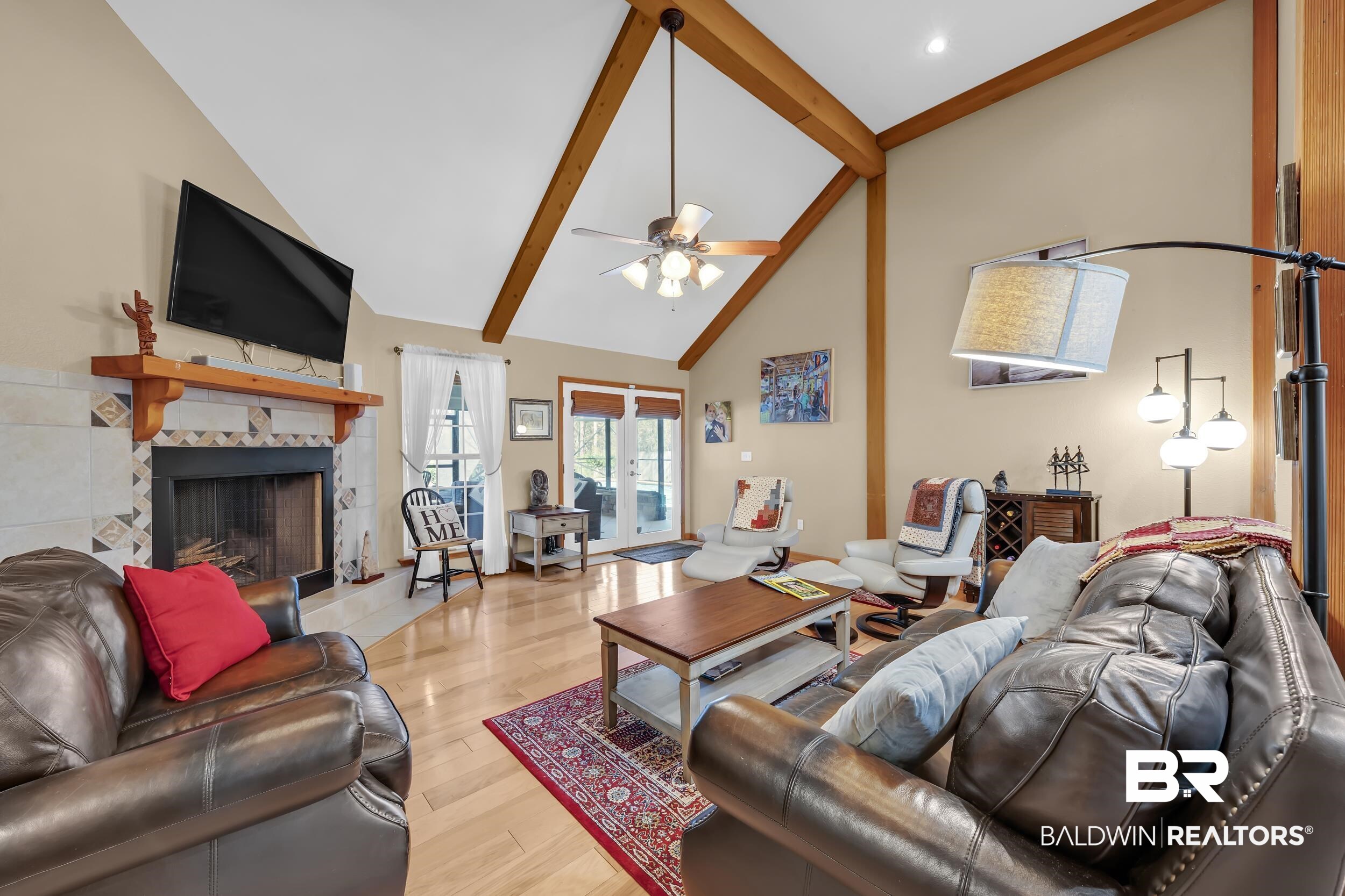 22929 Highway 98 Foley, AL 36535 - Photo 8 of 54 Living room featuring a tiled fireplace, light wood-style flooring, lofted ceiling, and a ceiling fan