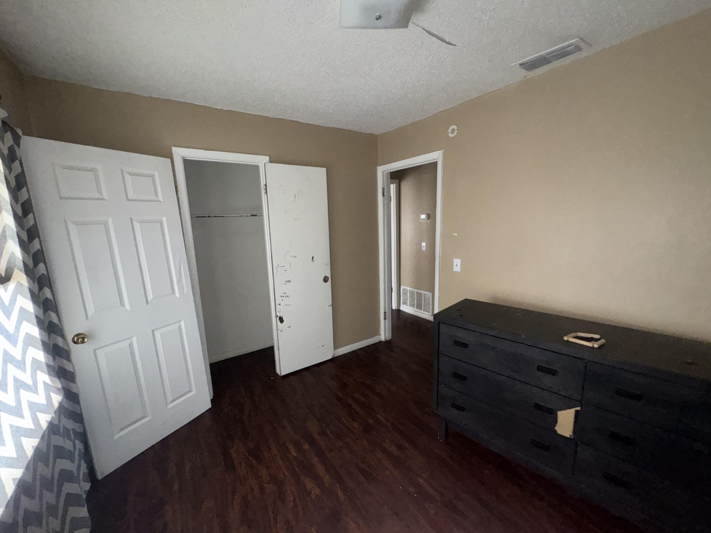 103 Pecos Place Plainview, TX 79072 - Photo 13 of 27 an empty room with wooden floor and cabinet