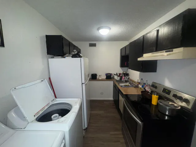 an empty room with wooden floor and entrance