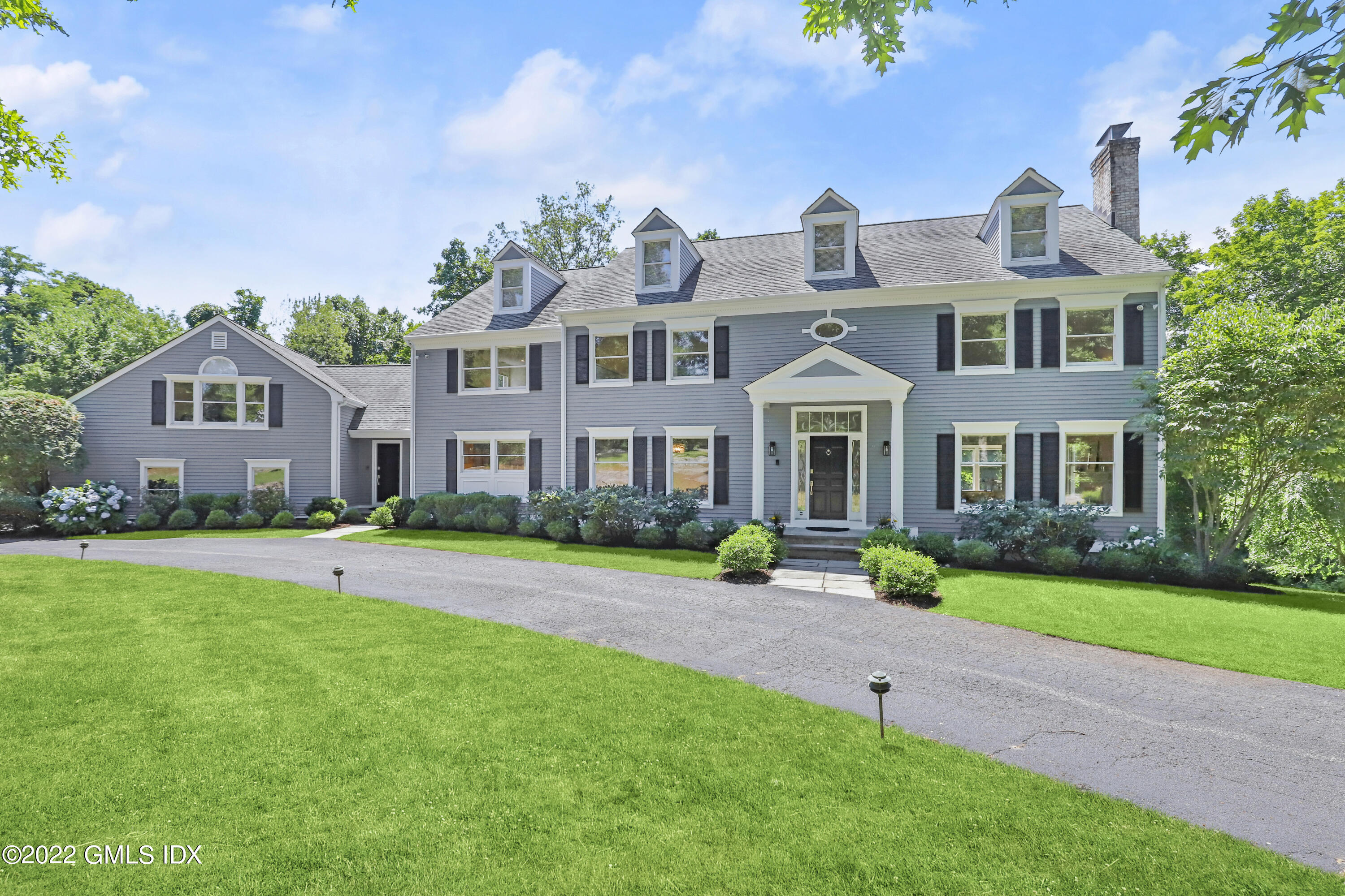 4 Juniper Hill Road Greenwich, CT 06830 - Photo 1 of 54 a front view of a house with a yard