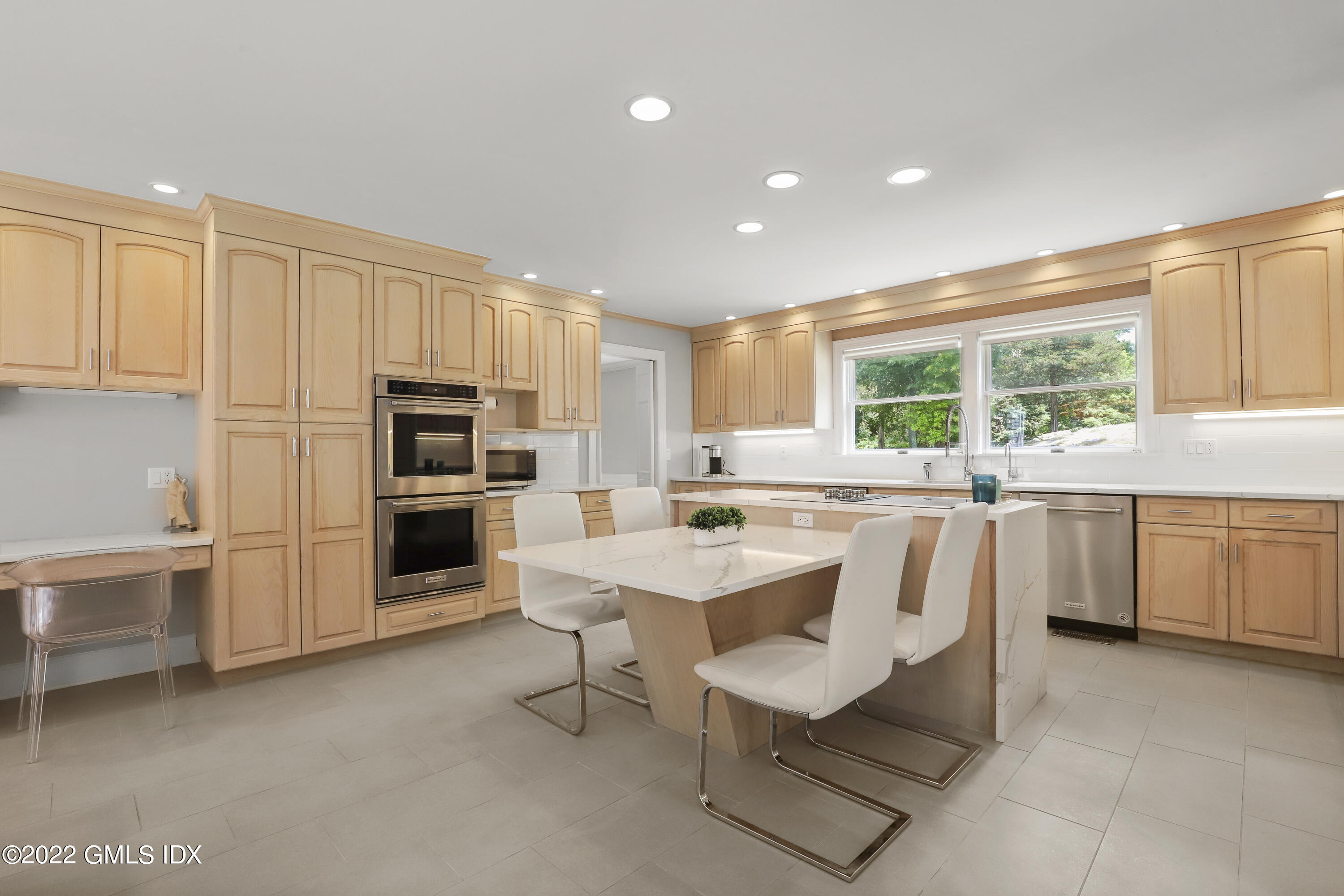 4 Juniper Hill Road Greenwich, CT 06830 - Photo 13 of 54 a kitchen with stainless steel appliances kitchen island granite countertop a sink a stove a refrigerator cabinets and chairs