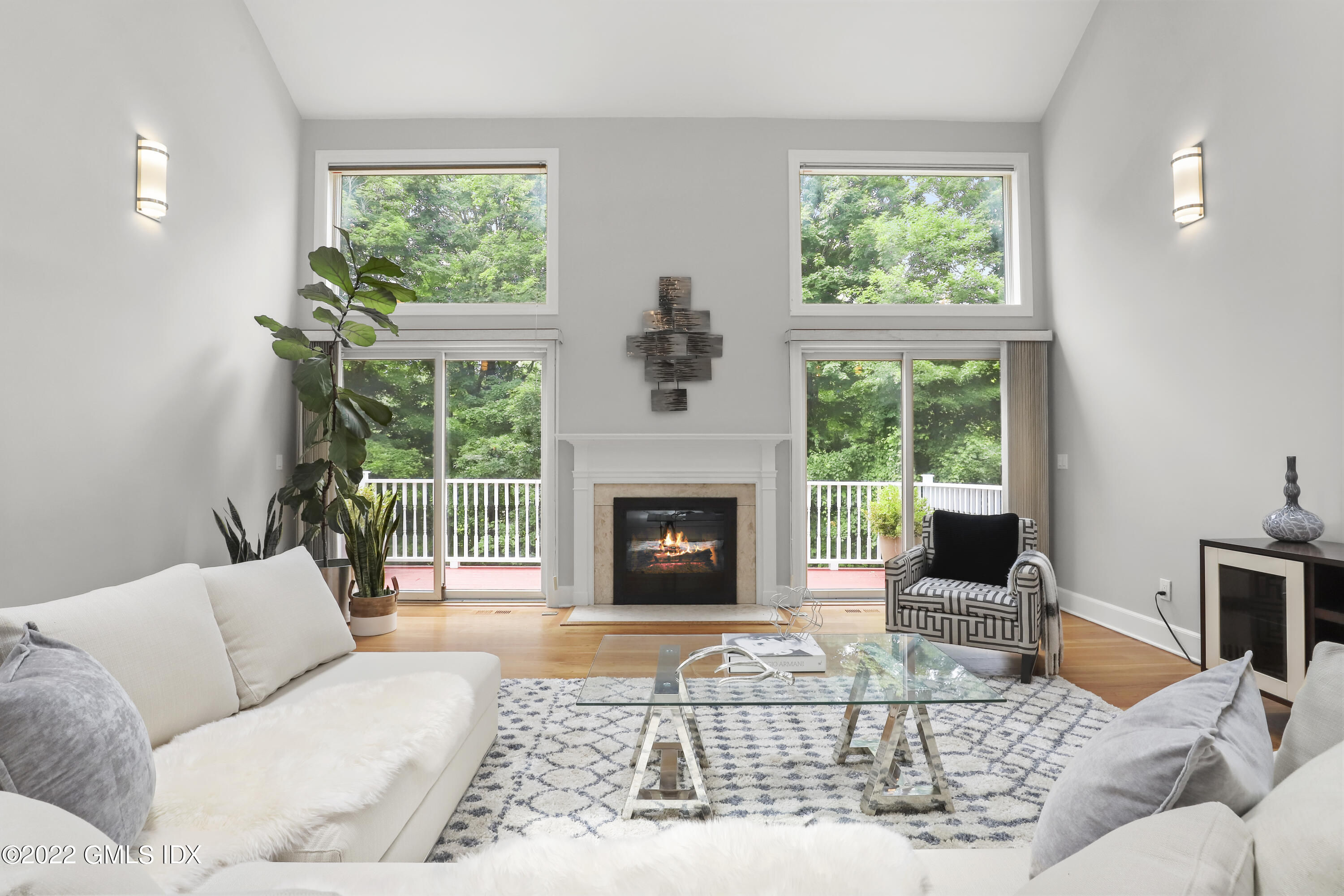 4 Juniper Hill Road Greenwich, CT 06830 - Photo 19 of 54 a living room with furniture large window and a fireplace