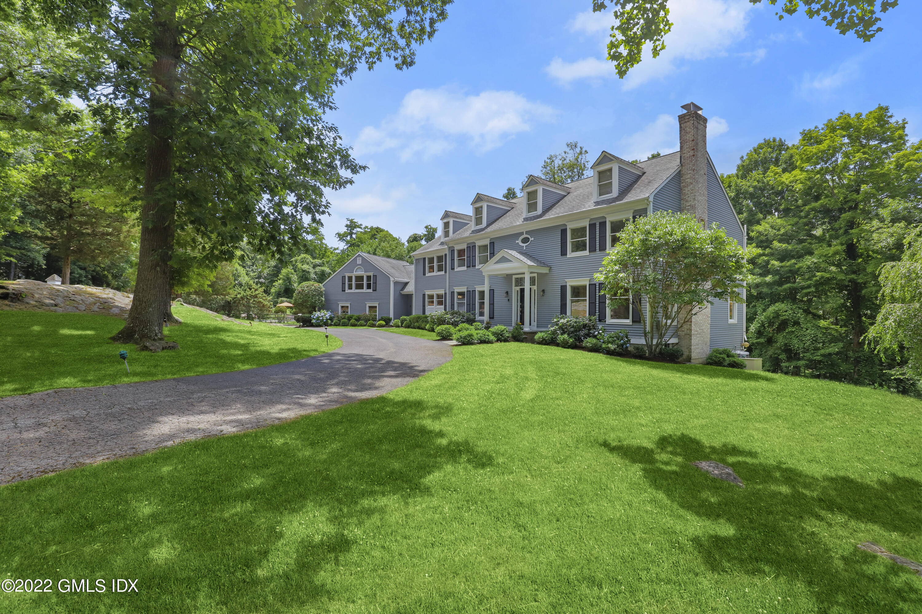 4 Juniper Hill Road Greenwich, CT 06830 - Photo 2 of 54 a front view of a house with garden