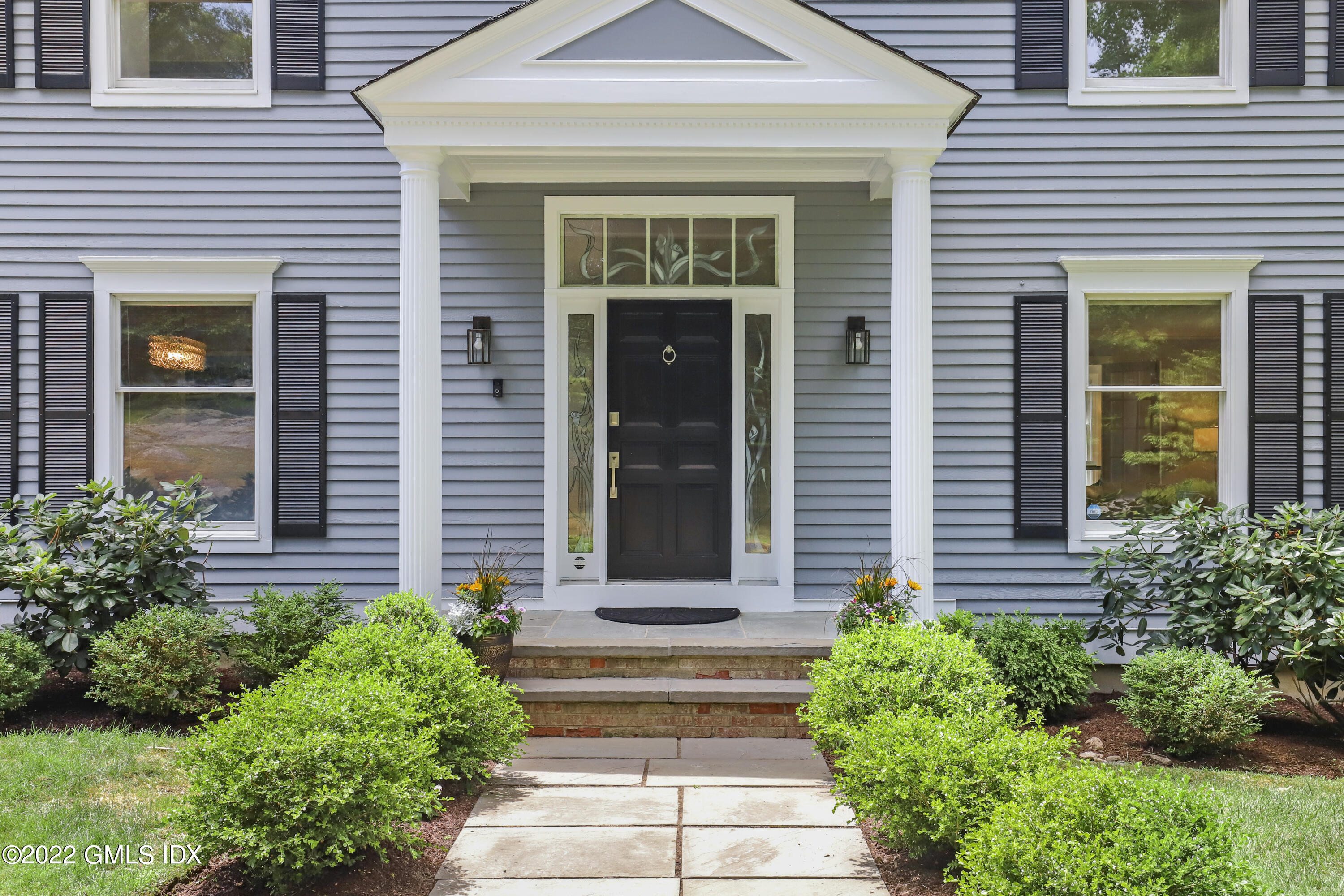 4 Juniper Hill Road Greenwich, CT 06830 - Photo 3 of 54 a front view of a house with potted plants