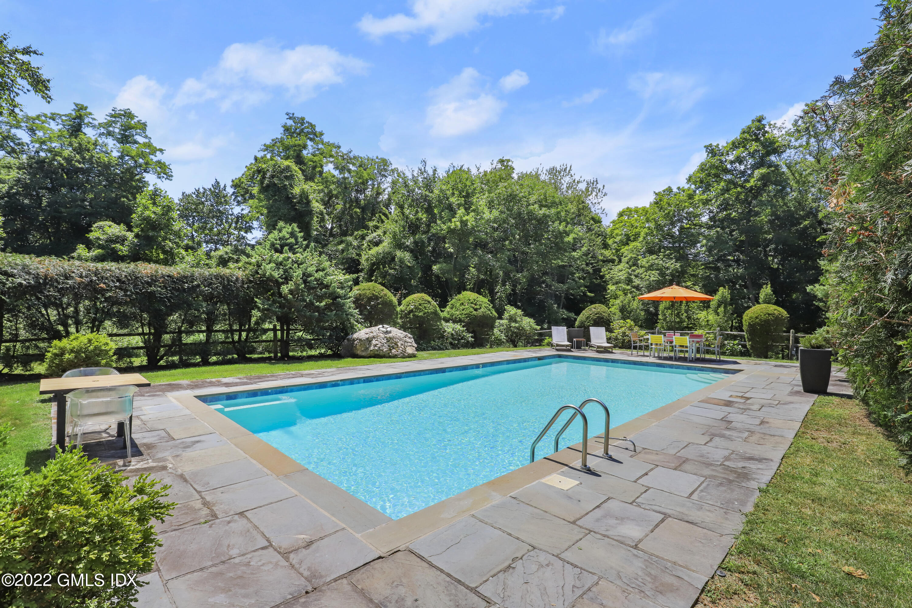 4 Juniper Hill Road Greenwich, CT 06830 - Photo 45 of 54 a view of swimming pool with seating space and trees in the background