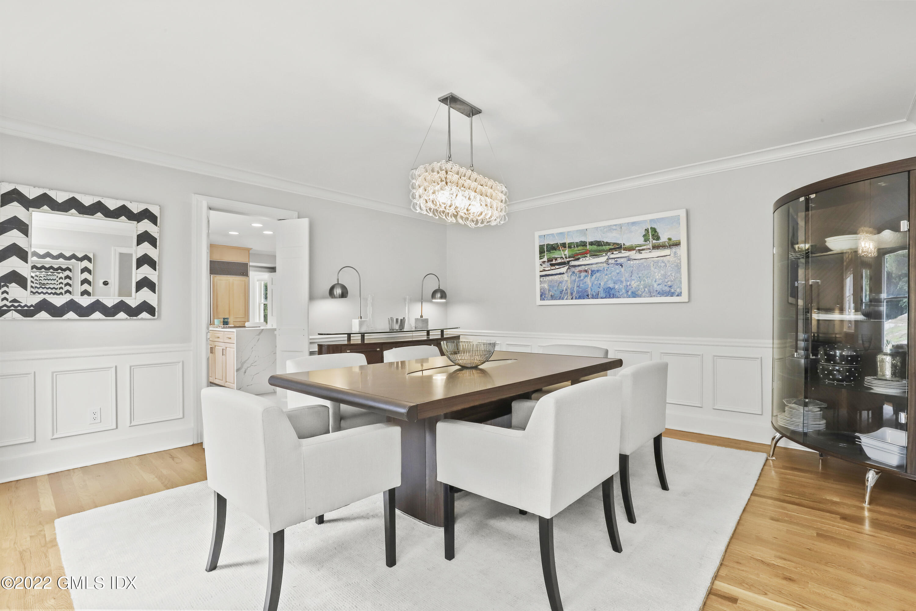 4 Juniper Hill Road Greenwich, CT 06830 - Photo 10 of 54 a dining room with wooden floor a chandelier a wooden table and chairs
