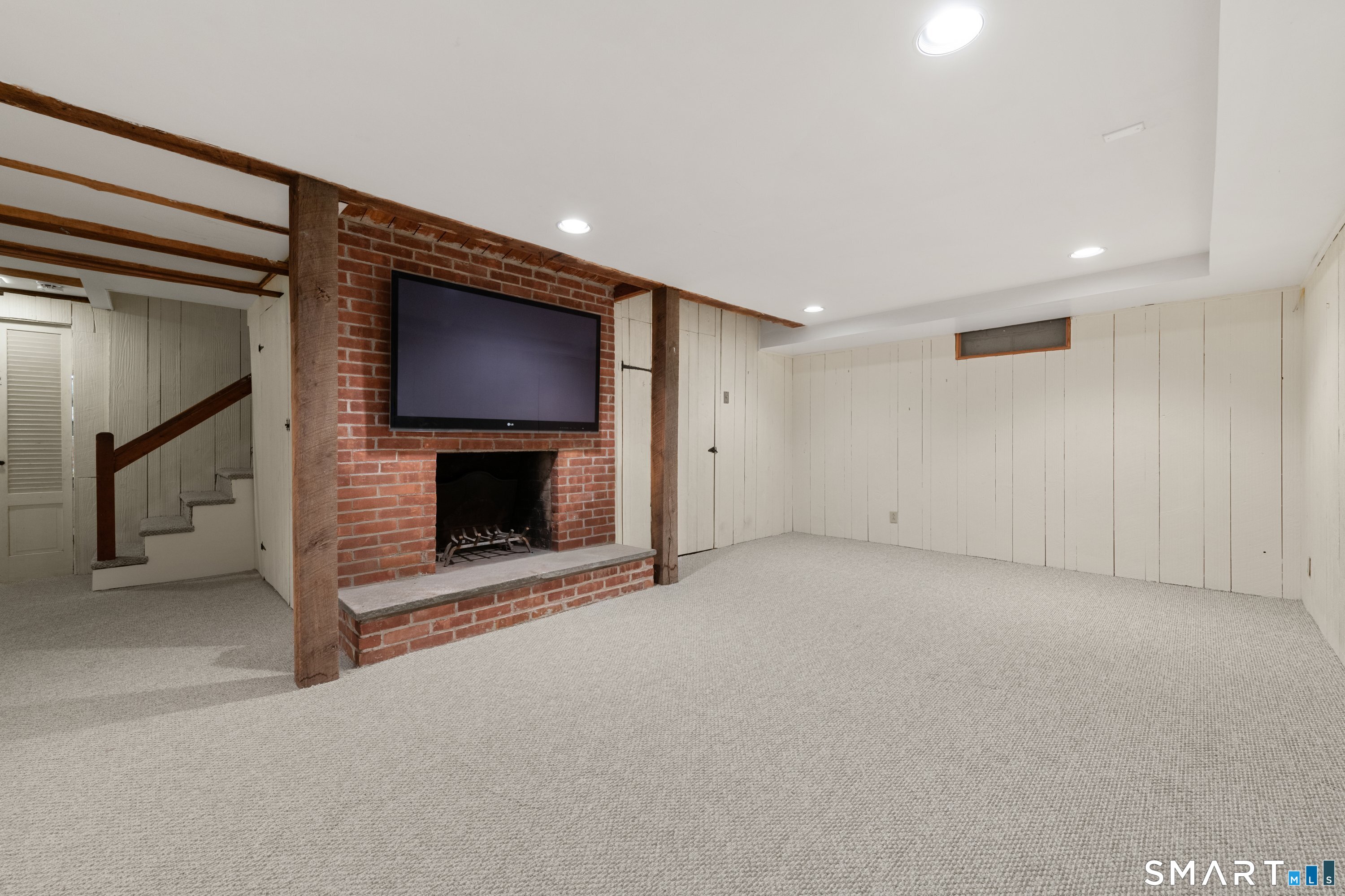 111 Lyons Plain Road Weston, CT 06883 - Photo 21 of 25 a view of an empty room with a fireplace