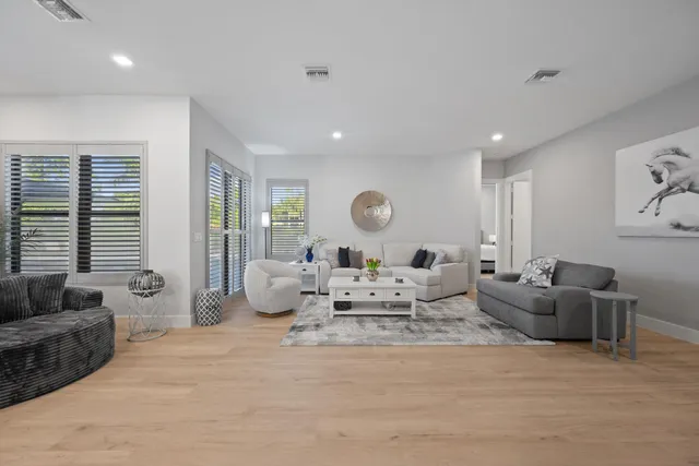 a bedroom with a bed a flat screen tv and a couch