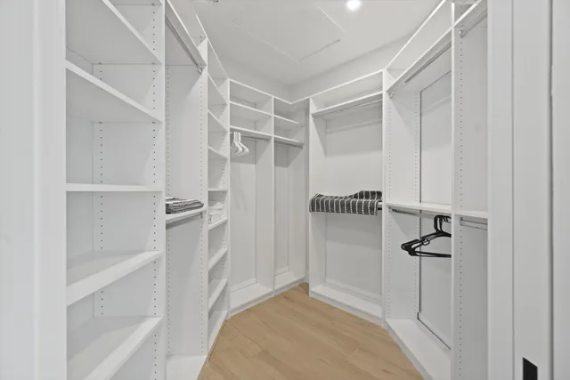 a bathroom with a sink a mirror and a bathtub next to a window