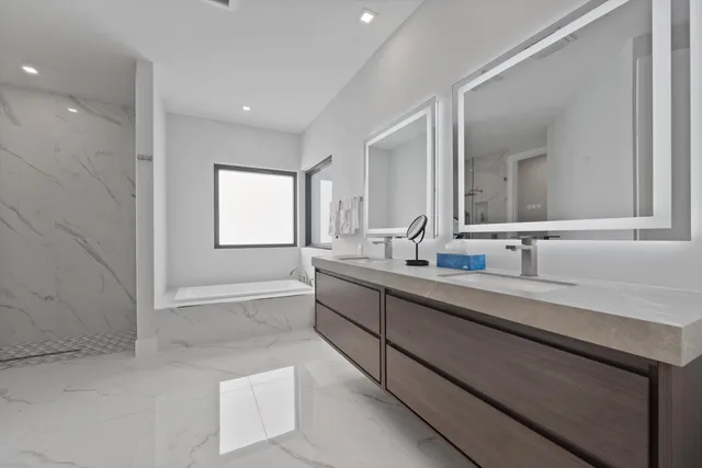 a spacious bathroom with a bathtub and a shower