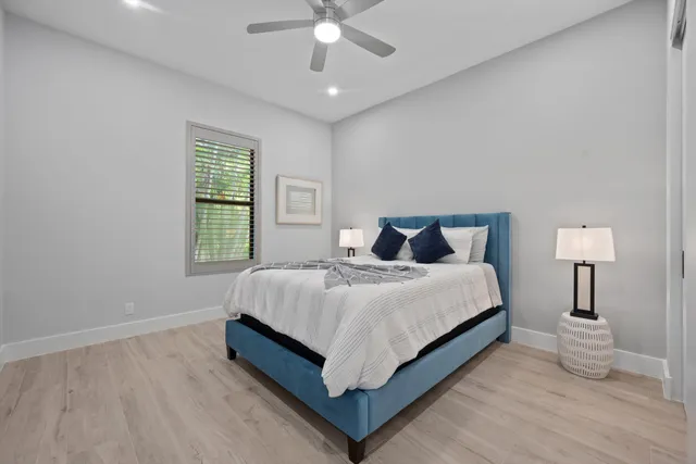 a bathroom with a granite countertop sink toilet and mirror
