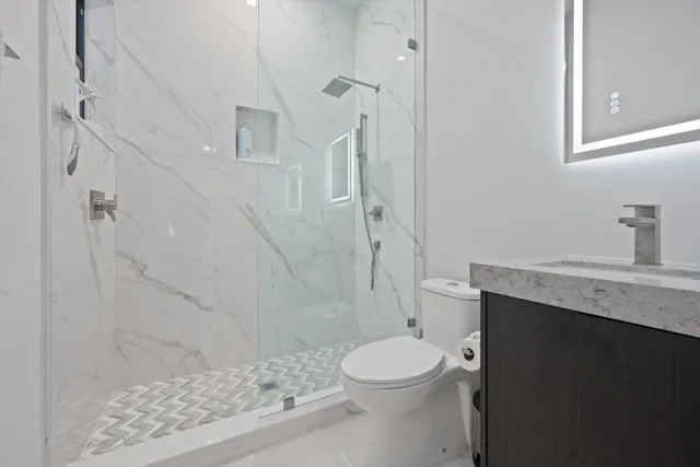 a bedroom with a large bed and a flat tv screen