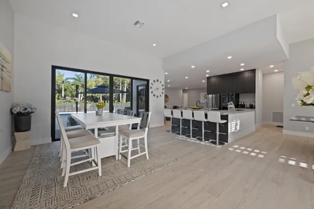 a dining room with furniture and a large window